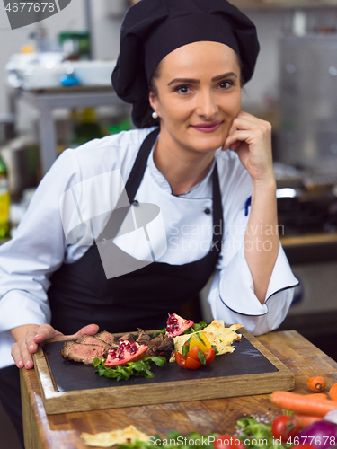 Image of female Chef preparing beef steak