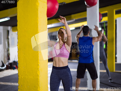 Image of young athletes working out with medical ball