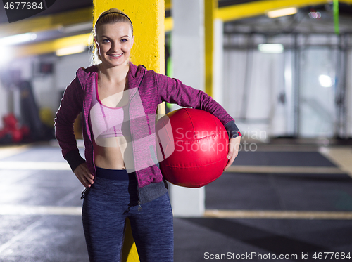 Image of portrait of woman with red crossfitness ball