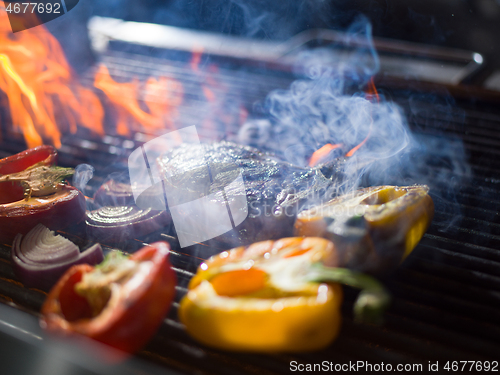 Image of steak with vegetables on a barbecue