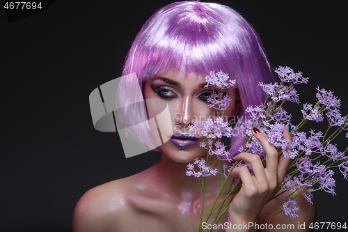 Image of Beautiful girl in purple wig with flowers