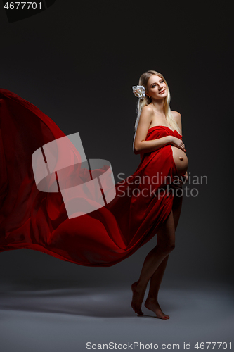 Image of Pregnant girl in red dress