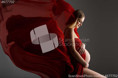 Image of Pregnant girl in red dress