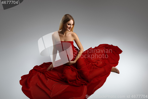 Image of Pregnant girl in red dress