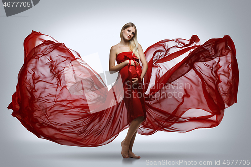 Image of Pregnant girl in red dress