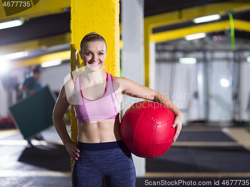 Image of portrait of woman with red crossfitness ball