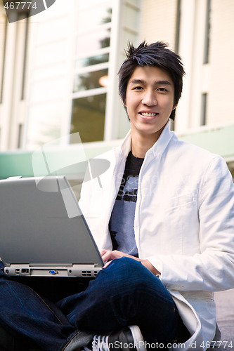 Image of Asian male student and laptop