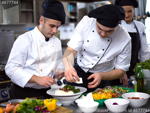 Image of Chef hands serving spaghetti