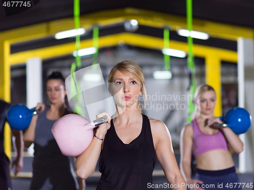 Image of athletes doing exercises with kettlebells