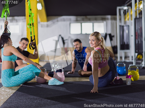 Image of young athletes sitting on the floor and relaxing