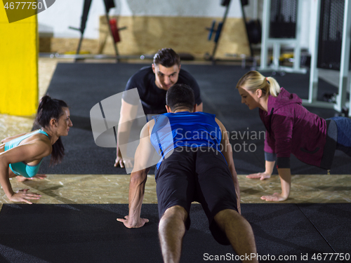 Image of young healthy people doing pushups