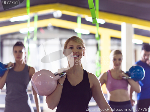 Image of athletes doing exercises with kettlebells