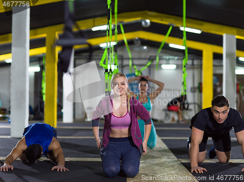 Image of young healthy people doing pushups