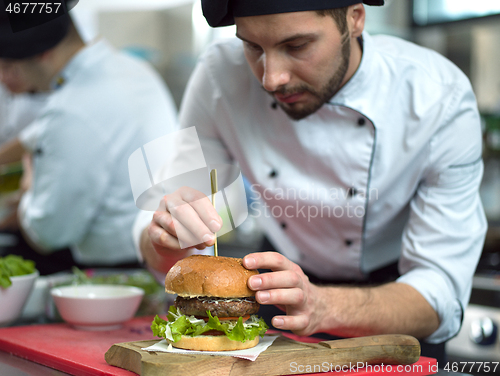 Image of chef finishing burger