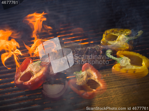 Image of steak with vegetables on a barbecue