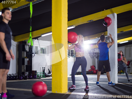 Image of young athletes working out with medical ball