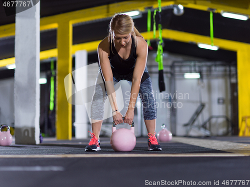 Image of woman exercise with fitness kettlebell