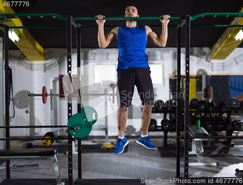 Image of man doing pull ups on the horizontal bar