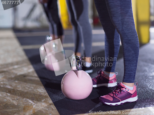 Image of athletes doing exercises with kettlebells