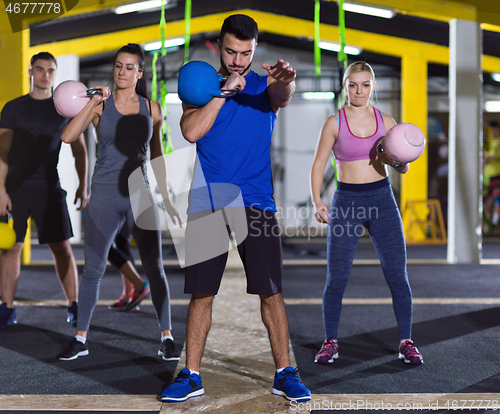 Image of athletes doing exercises with kettlebells