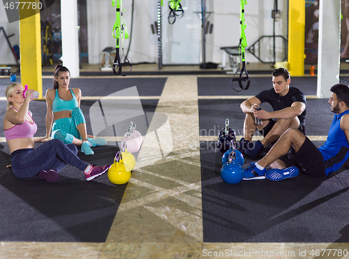 Image of young athletes sitting on the floor and relaxing