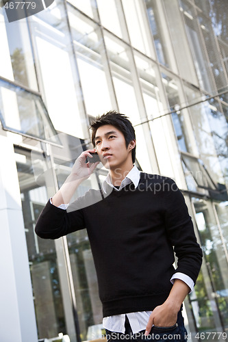 Image of Casual asian businessman on the phone