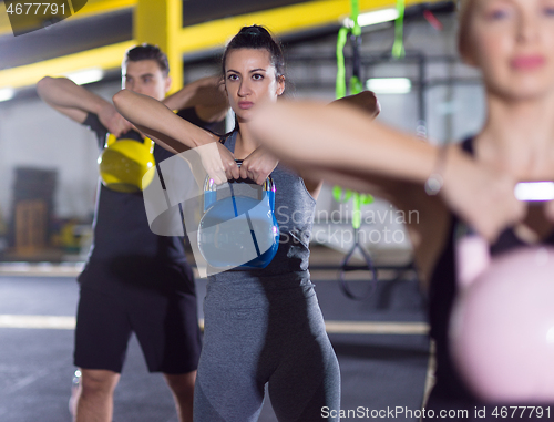 Image of athletes doing exercises with kettlebells