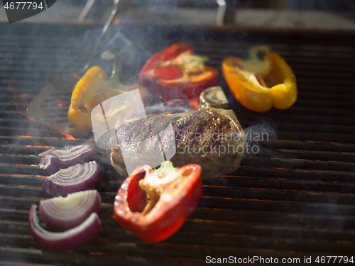 Image of steak with vegetables on a barbecue