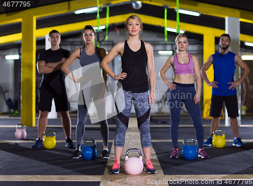 Image of athletes doing exercises with kettlebells