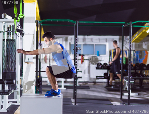 Image of man working out jumping on fit box