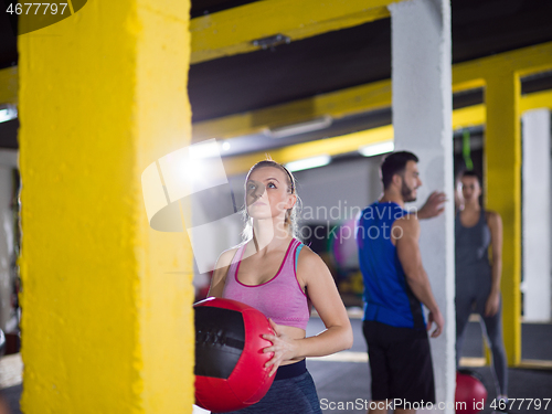 Image of young athletes working out with medical ball