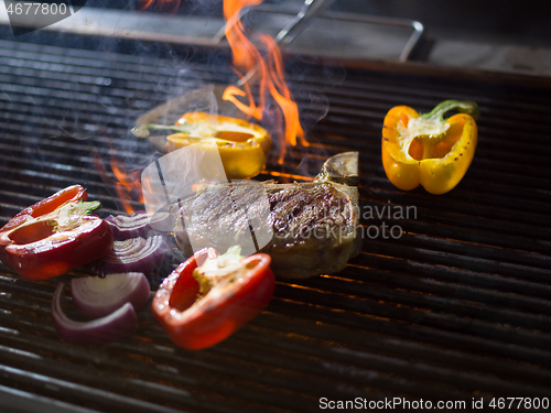 Image of steak with vegetables on a barbecue