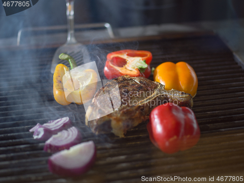 Image of steak with vegetables on a barbecue