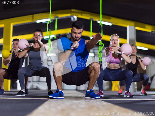 Image of athletes doing exercises with kettlebells