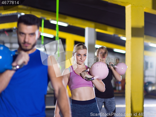 Image of athletes doing exercises with kettlebells