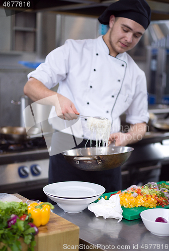 Image of Chef hands serving spaghetti