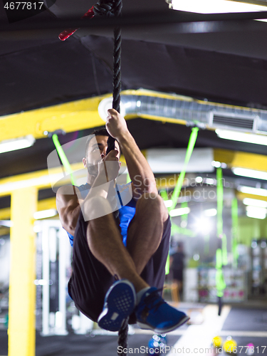 Image of man doing rope climbing