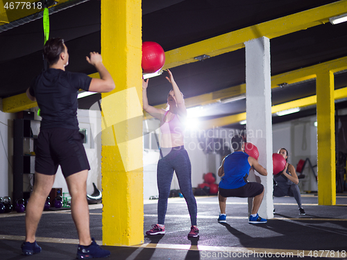 Image of young athletes working out with medical ball