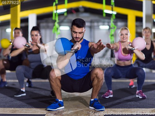 Image of athletes doing exercises with kettlebells