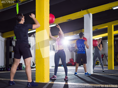 Image of young athletes working out with medical ball