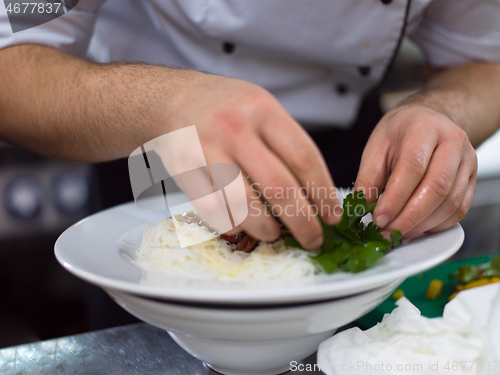 Image of Chef hands serving spaghetti