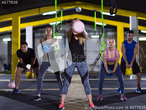 Image of athletes doing exercises with kettlebells