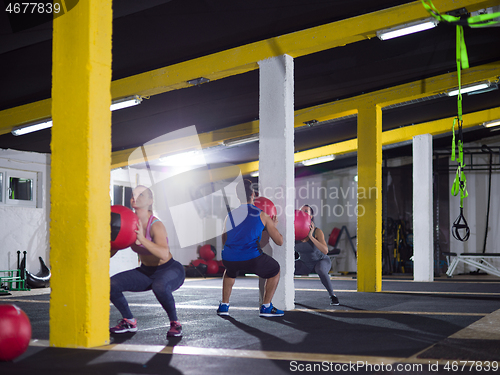 Image of young athletes working out with medical ball