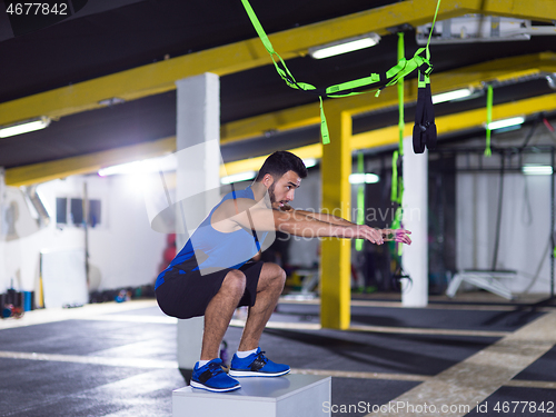 Image of man working out jumping on fit box