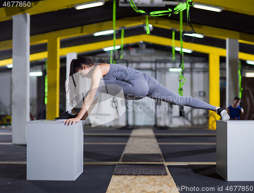 Image of woman working out gymnastic exercise on fit boxes