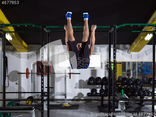 Image of man doing pull ups on the horizontal bar