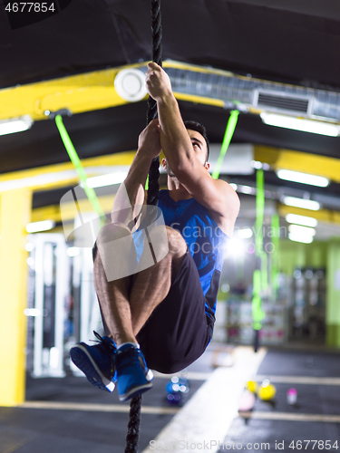 Image of man doing rope climbing