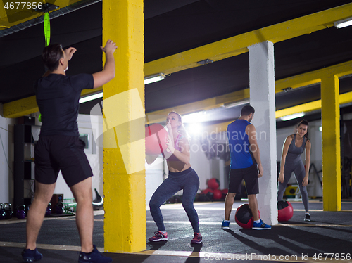 Image of young athletes working out with medical ball