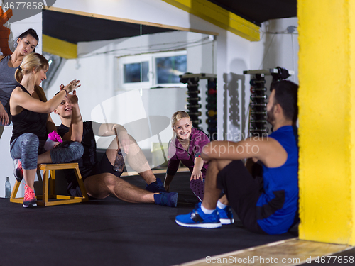 Image of young athletes sitting on the floor and relaxing