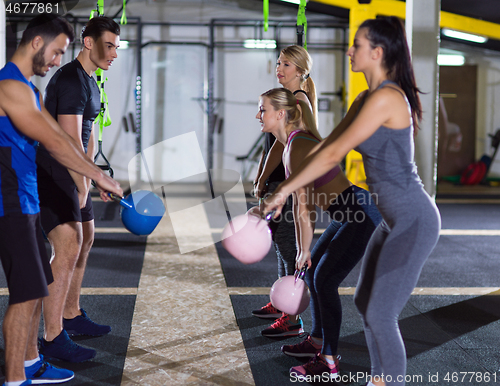 Image of athletes doing exercises with kettlebells